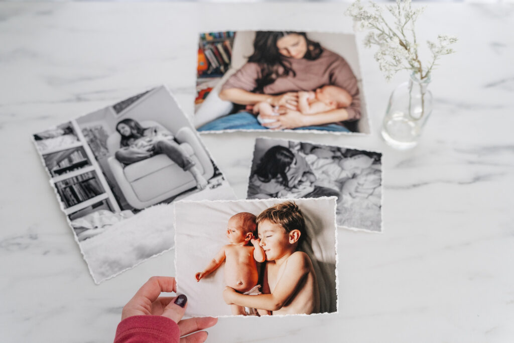 four photographs of children, hand holds front photo of newborn and child