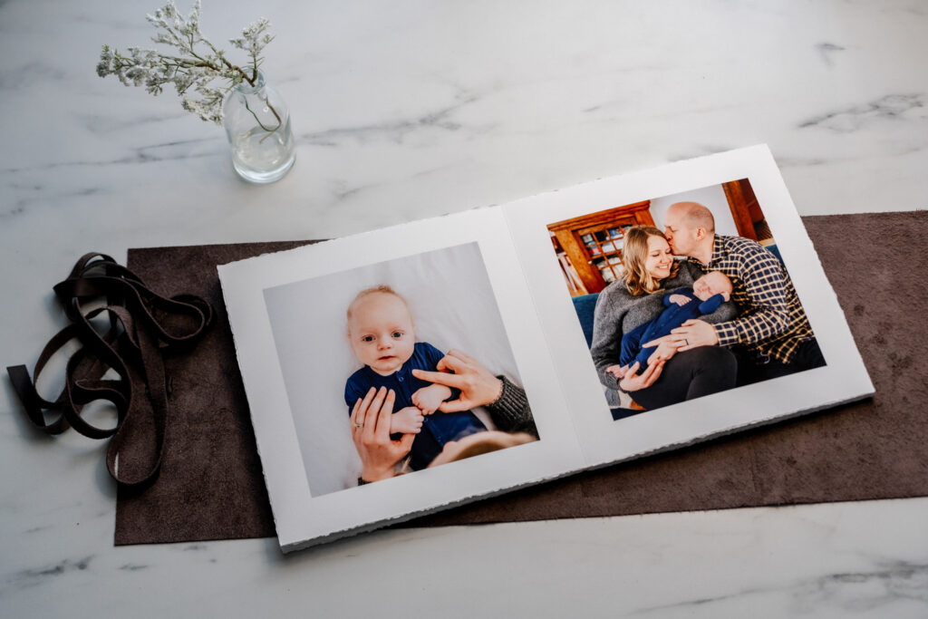 Photo album with two images, one of baby and one of parents and baby.