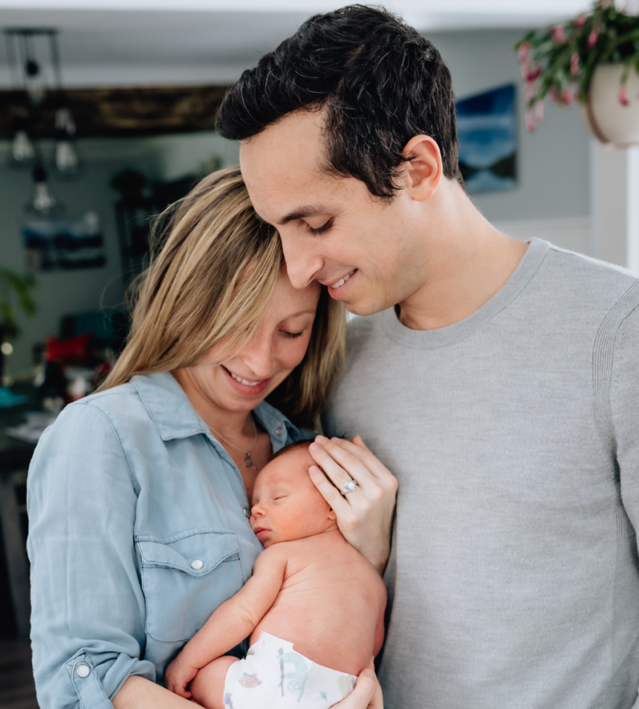 mother and father holding their baby