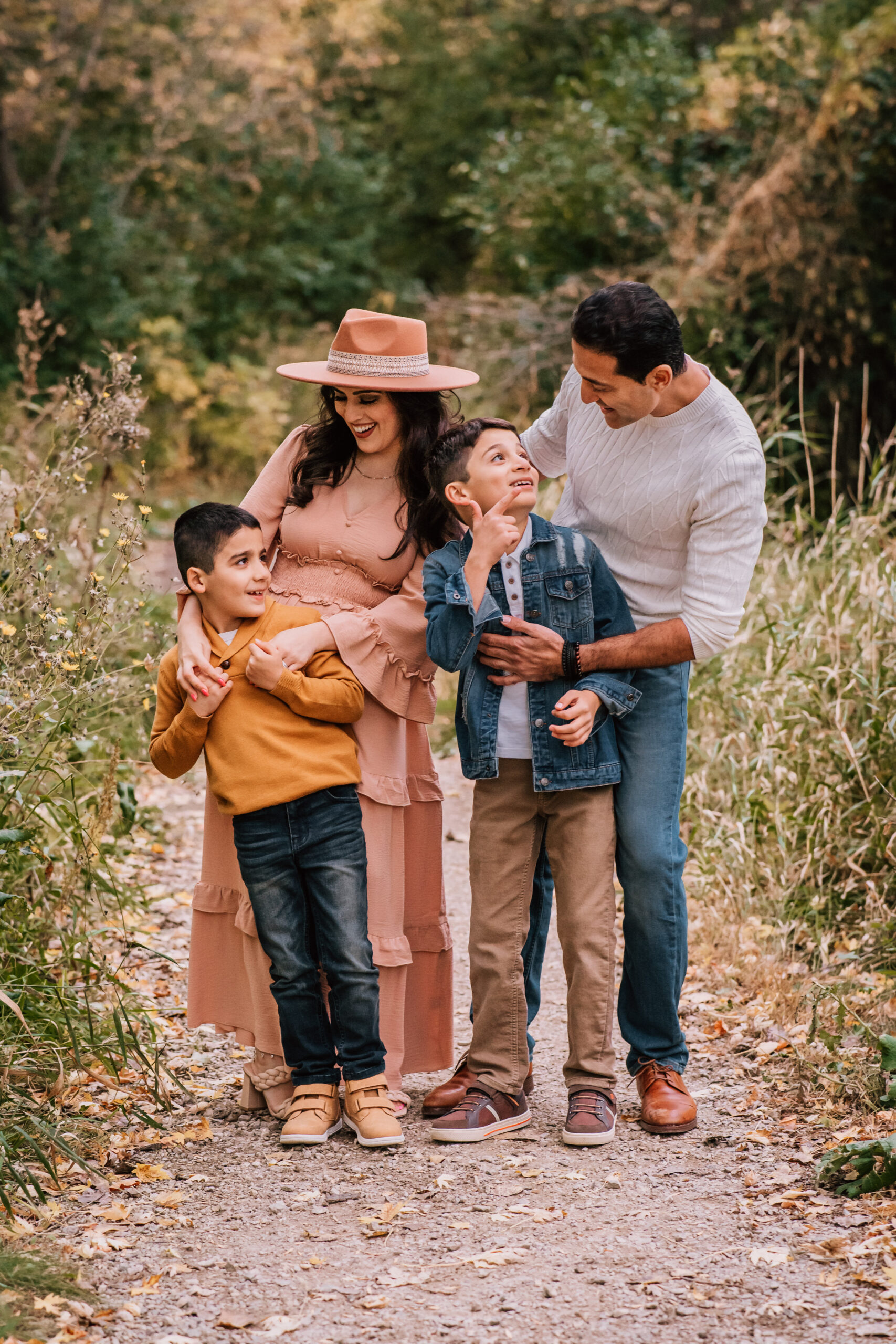 family of four looking at each other and laughing. 