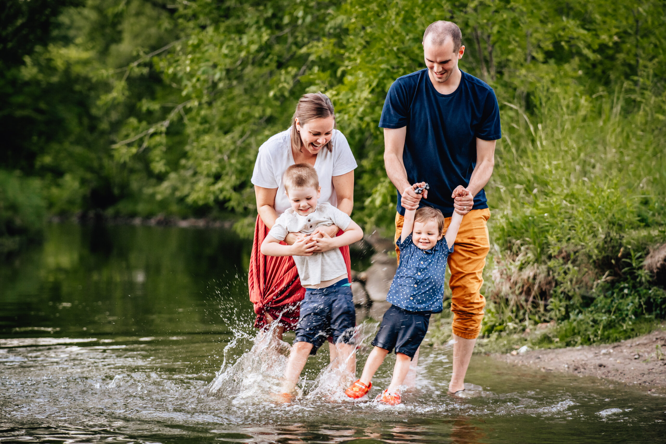 family of four playing in the water together 