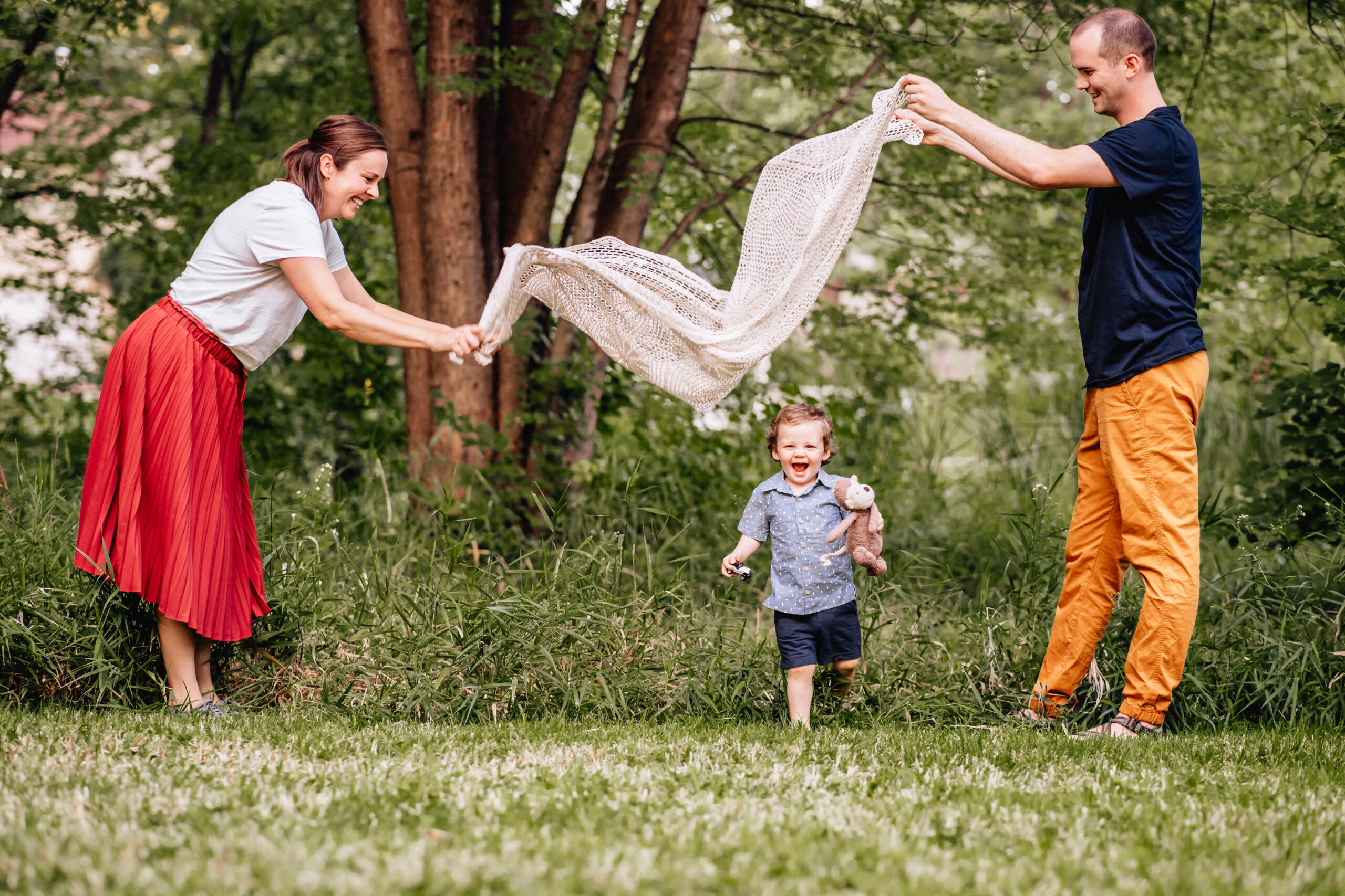 father and mother playing with their young son