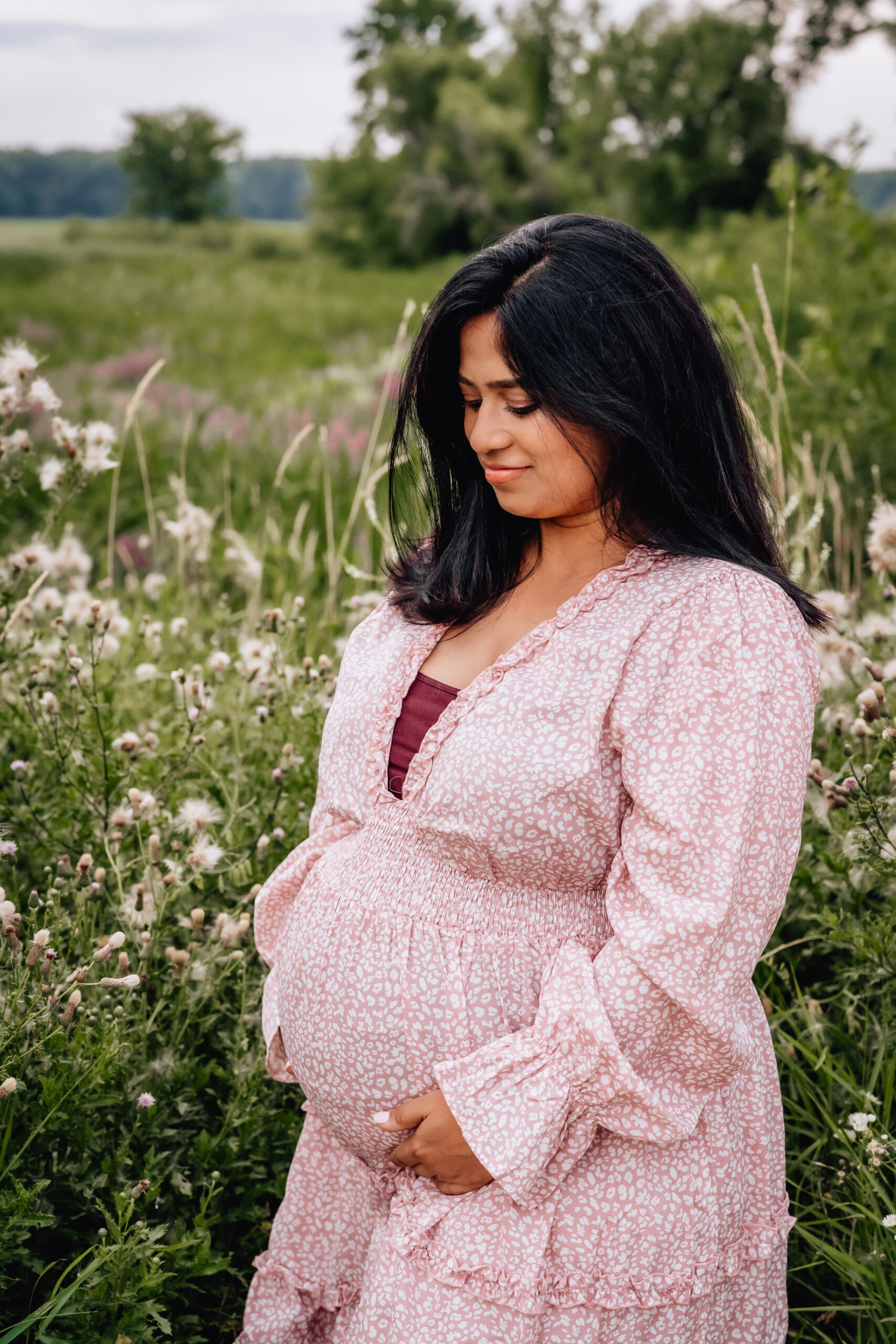 expecting mother in a field of wildflowers. 