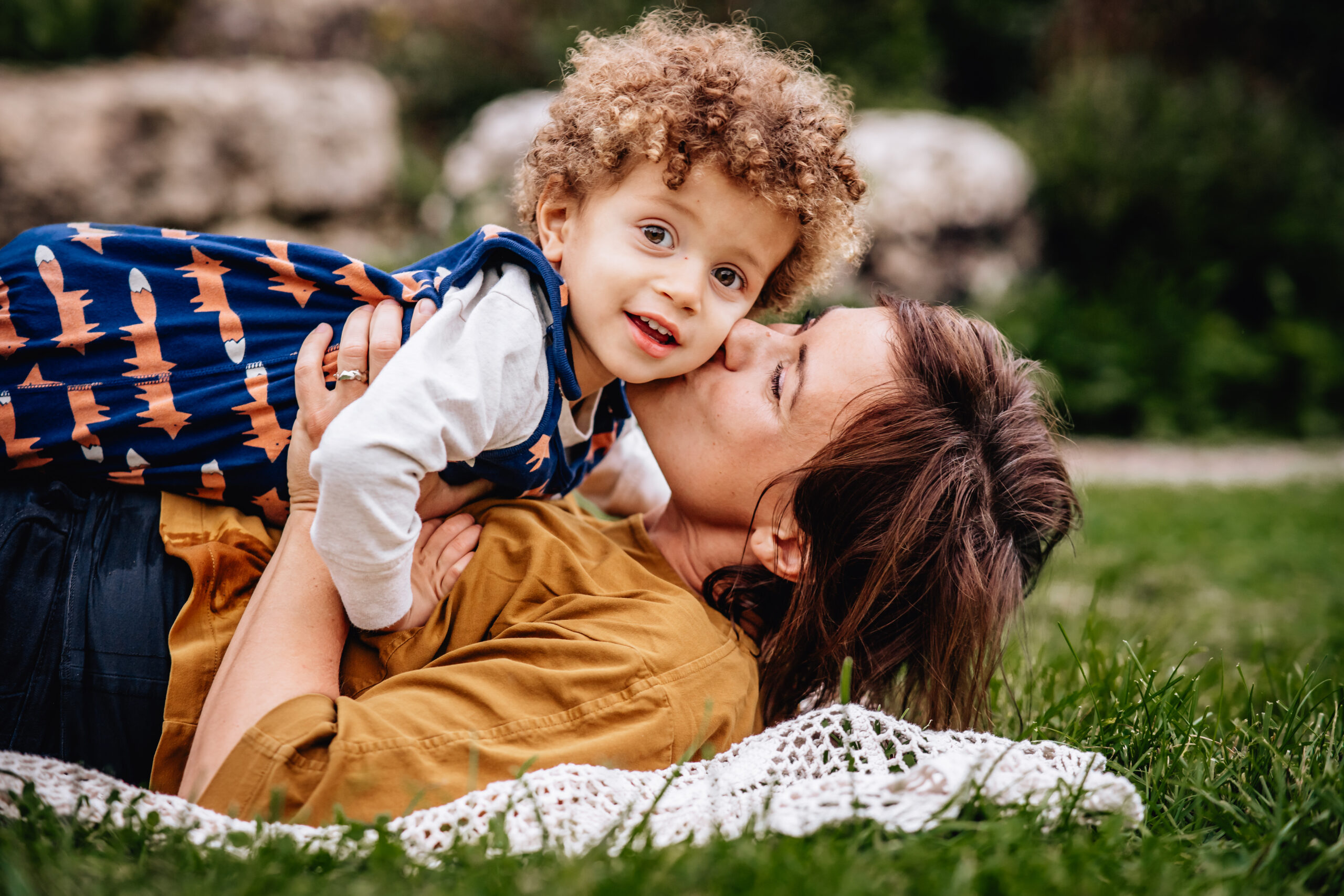 mother giving her toddler son a kiss on the cheek