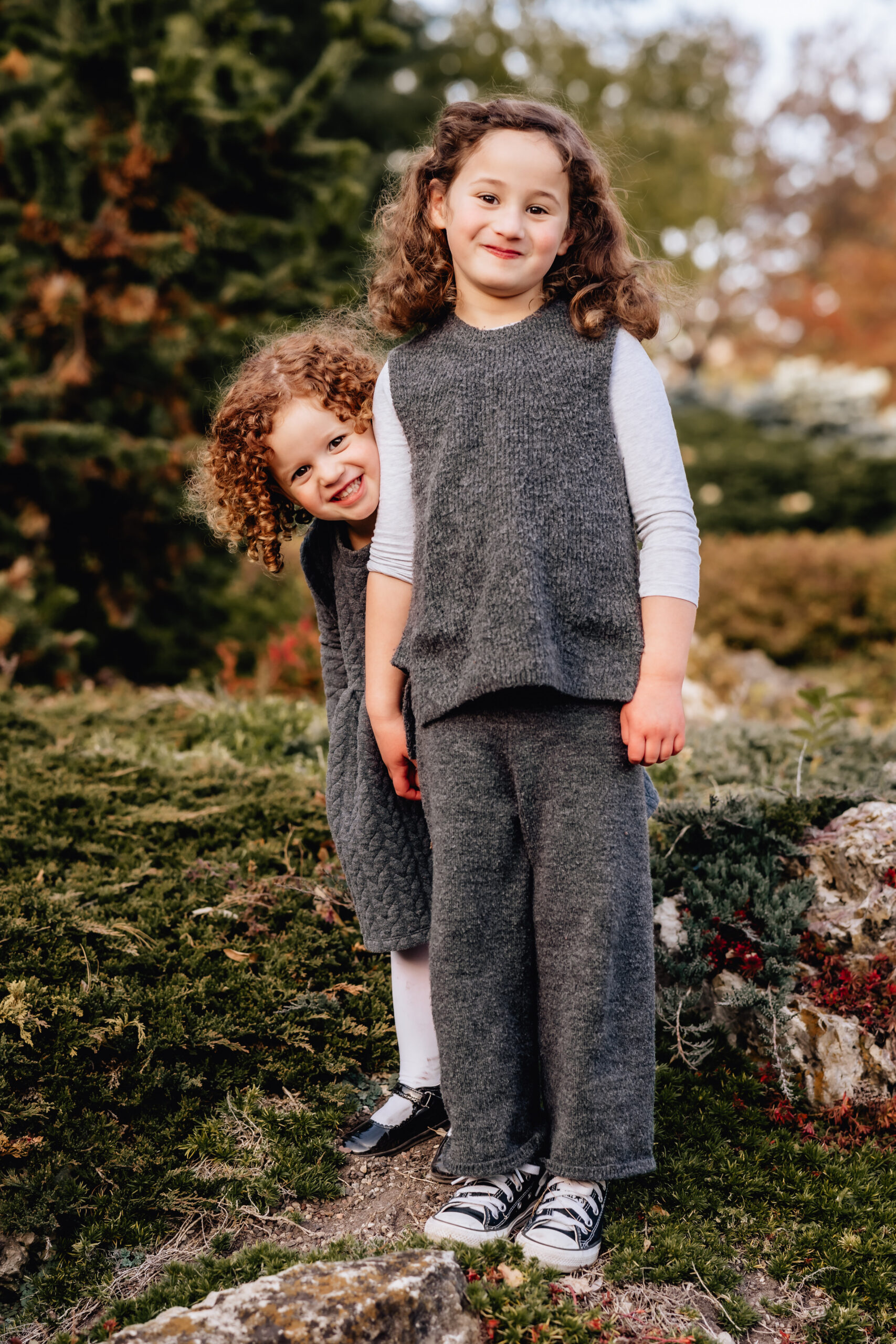 two sisters laughing and looking at the camera