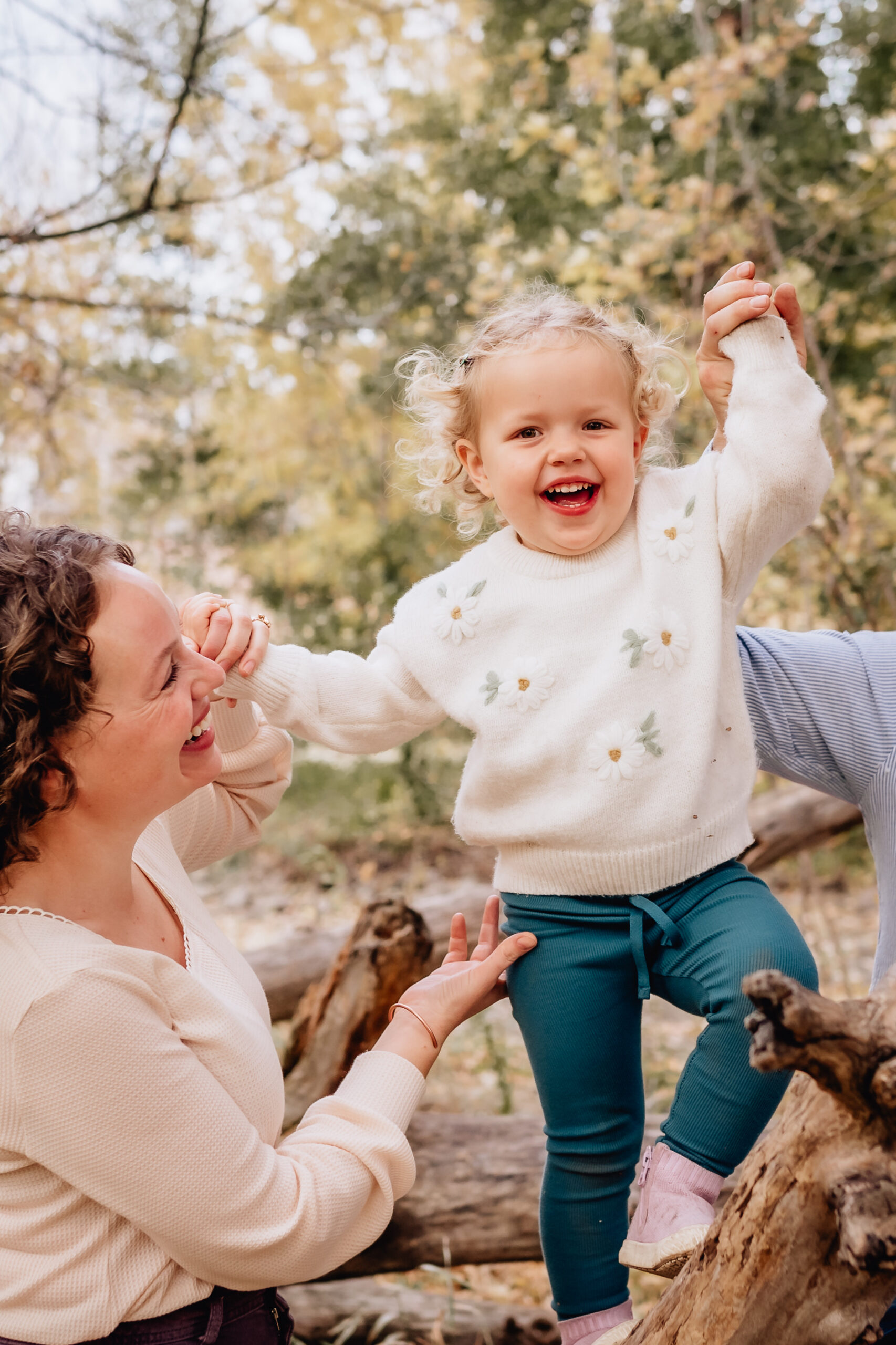 mother and toddle daughter laughing together 