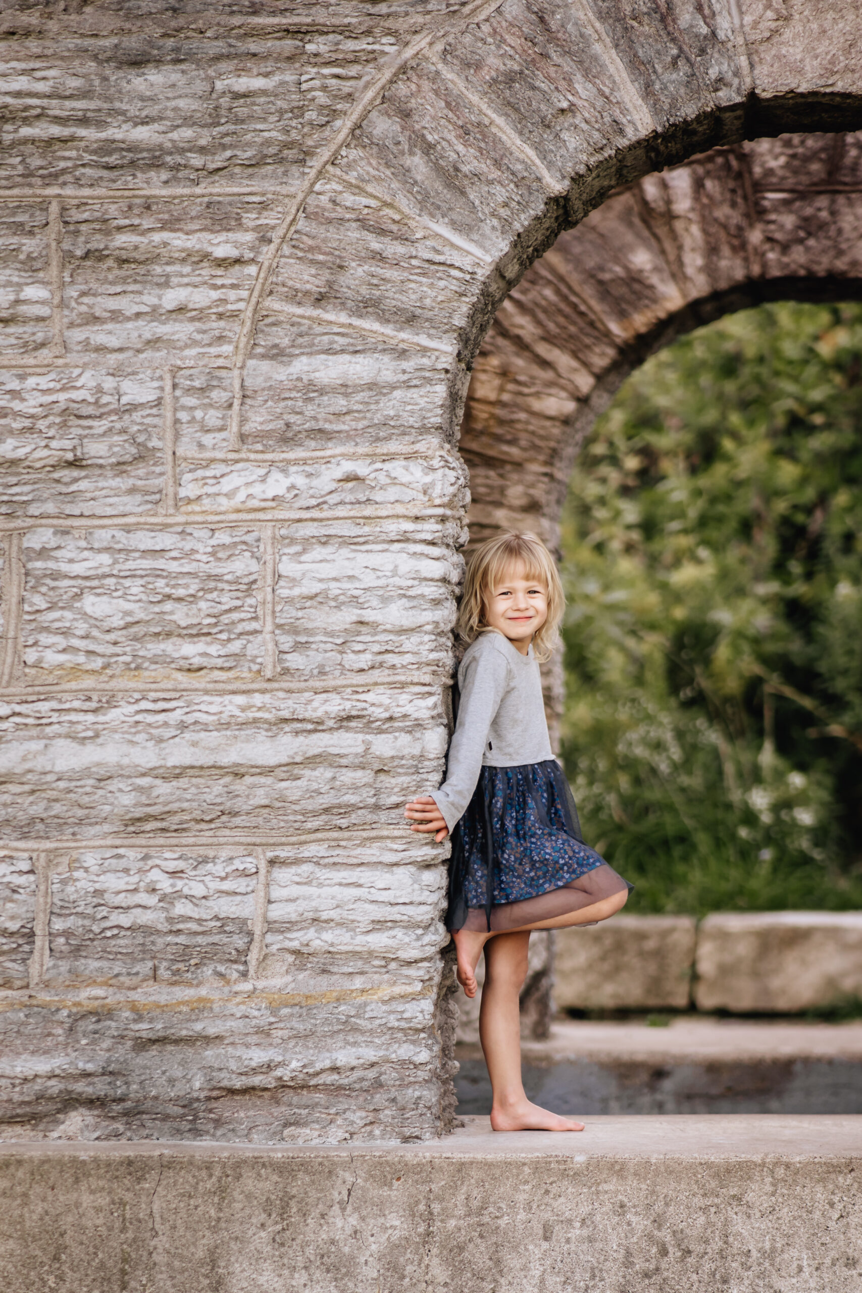 young girl posing underneath a walkway at Coldwater Spring 